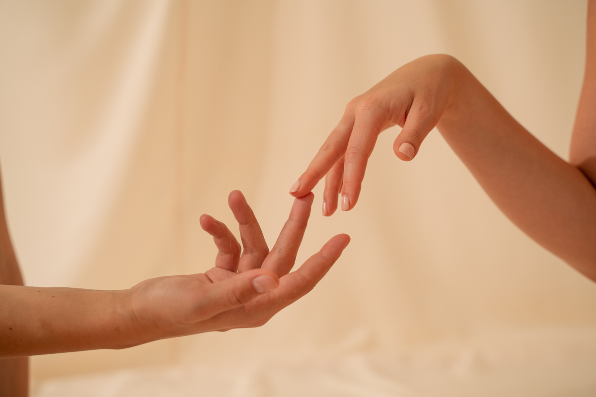 Two Persons Touching Hands